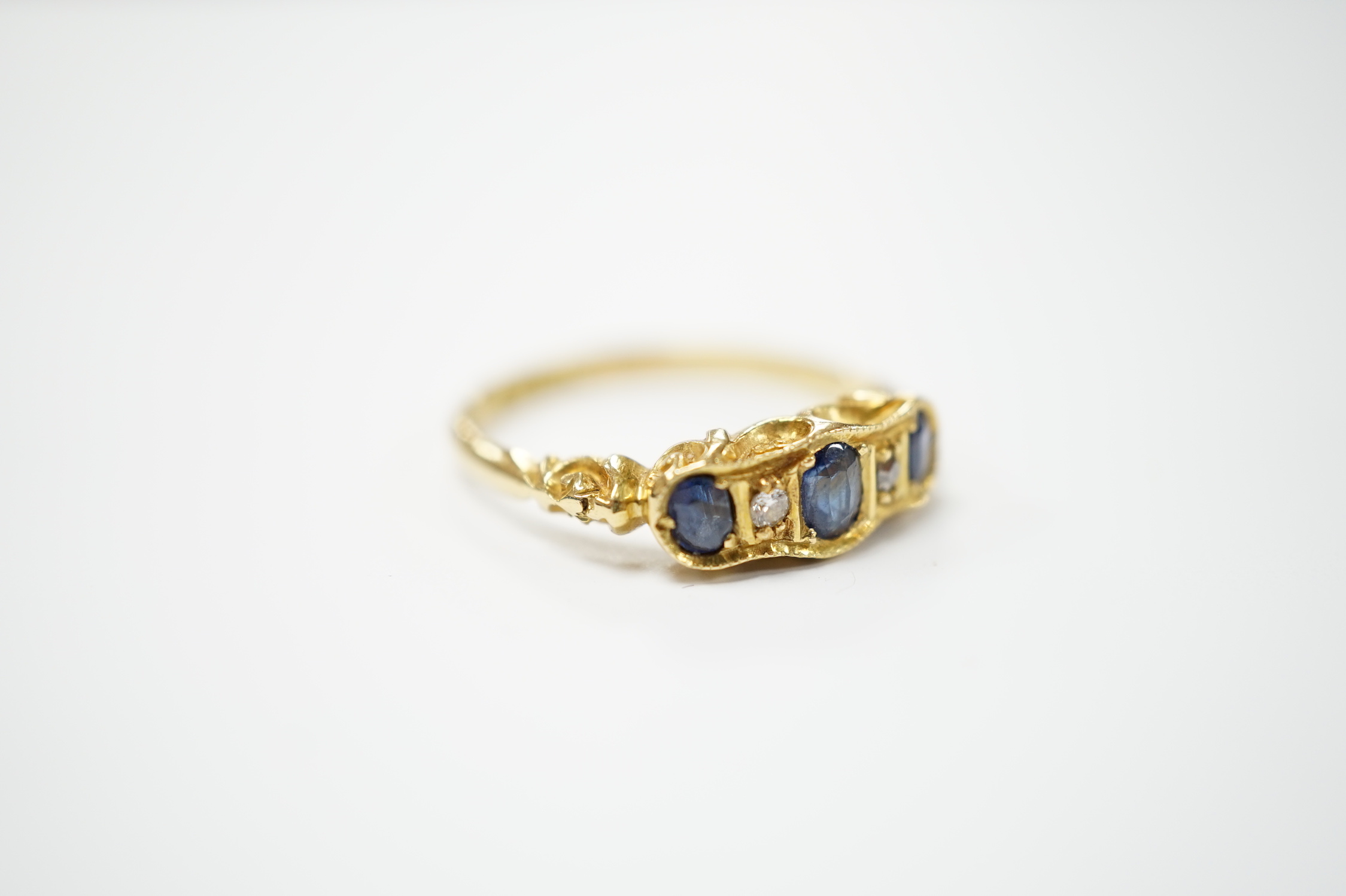 A late Victorian 18ct gold, sapphire and diamond ring, size N, gross weight 3.1 grams.